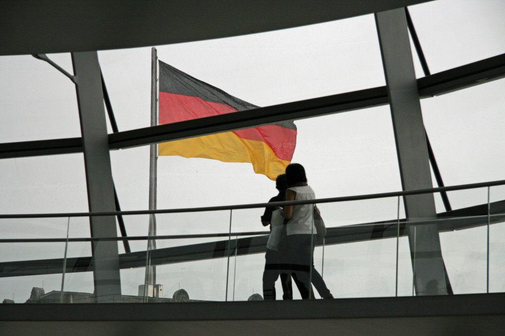 Tourists passing the German flag as they climb the dome of the Reichstag in Berlin