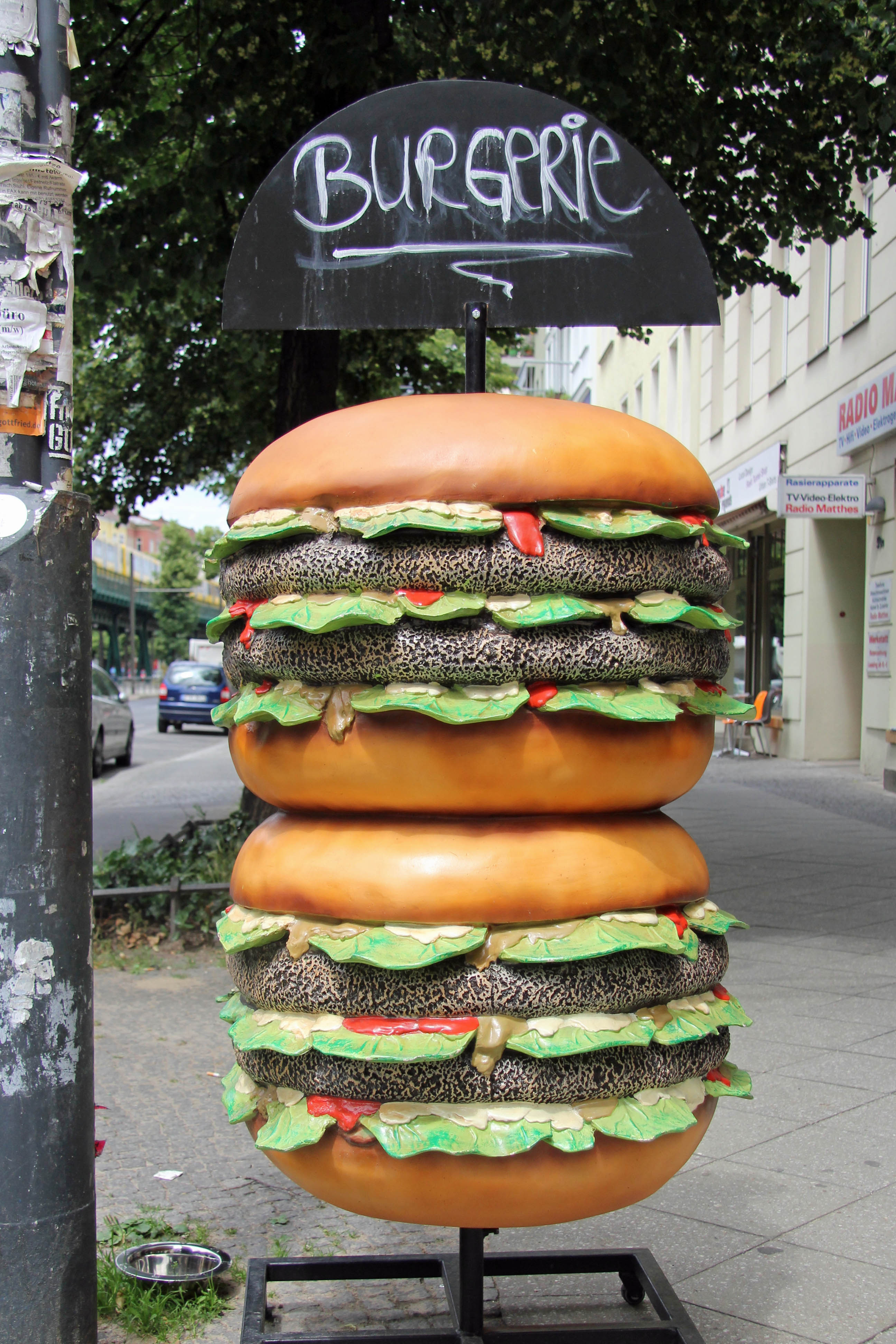 The Burgerie sign - a giant burger stack on the pavement on Schönhauser Allee in Berlin