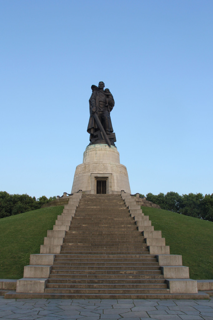 The statue of a Soviet soldier carrying a German child and crushing a Swastika beneath his boot at the Soviet War Memorial in Treptower Park in Berlin