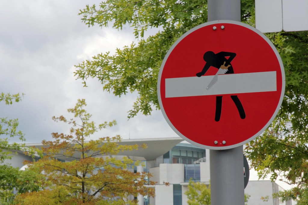 Sawing: A street sign intervention - the clever street (sign) art of CLET in Berlin