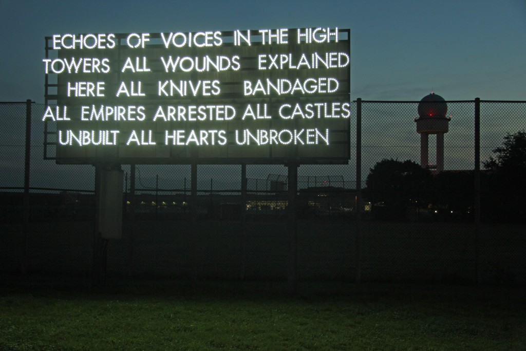Echoes of voices in the high towers – a light installation by Robert Montgomery at the former Tempelhof Airport in Berlin