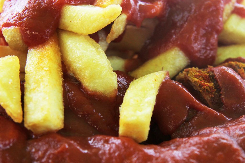 Close Up of Currywurst and Chips (Pommes) at Curry Baude in Berlin Gesundbrunnen