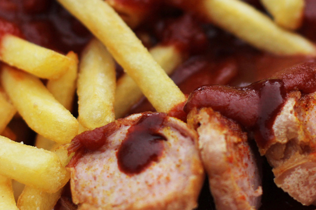 Close up of Currywurst & Chips (Currywurst & Pommes) at Curry & Chili Berlin - one of the best Currywurst in Berlin