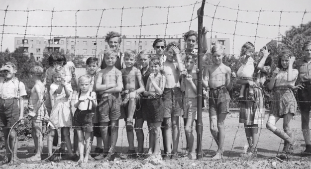 Children at the fence at Tempelhof Airport Berlin during the Berlin Blockade of 1948 and 1949 - Still from 'The Candy Bomber' by KUED
