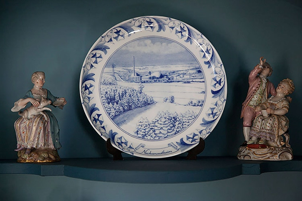 A display suggestion for a plate from Atomteller, a range of porcelain wall plates with blue and white designs of German nuclear power plants in idyllic landscapes