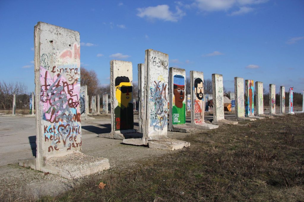 Berlin Wall Graveyard - Painted sections of the Berlin wall on waste ground in Teltow that will soon be part of the Teltow Marina - Photo February 2014