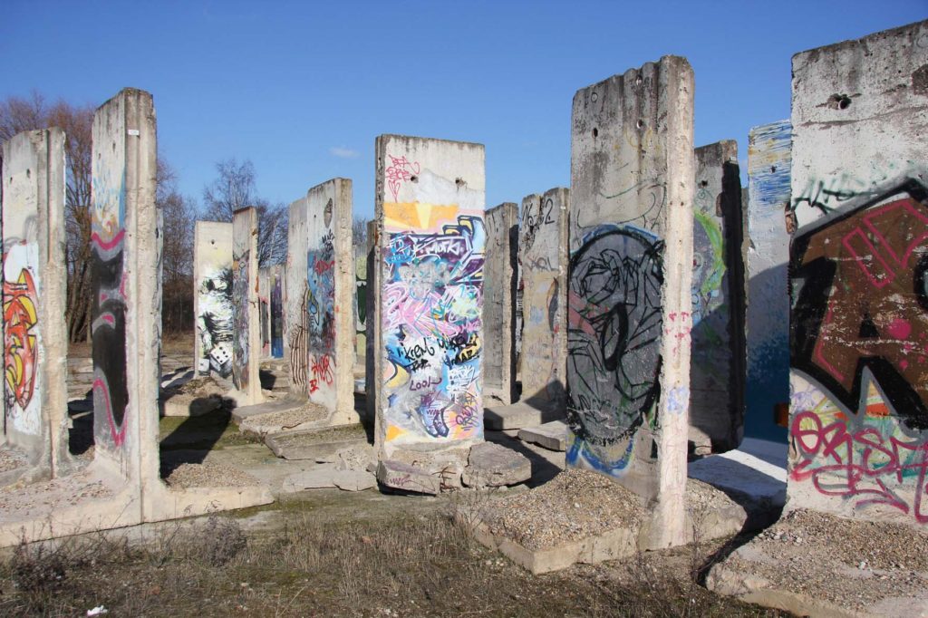 Berlin Wall Graveyard - Graffitied sections of the Berlin wall on waste ground in Teltow that will soon be part of the Teltow Marina - Photo February 2014