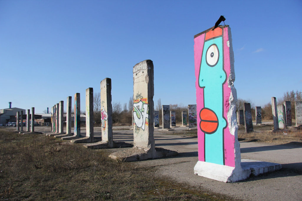 Berlin Wall Graveyard - Painted sections of the Berlin wall on waste ground in Teltow that will soon be part of the Teltow Marina, including a piece by Thierry Noir - Photo February 2014