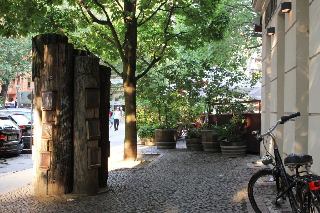 Bücherwald (book forest) - a lending library with shelves carved into logs bolted together to resemble a tree on Sredzkistrasse in Berlin Prenzlauer Berg