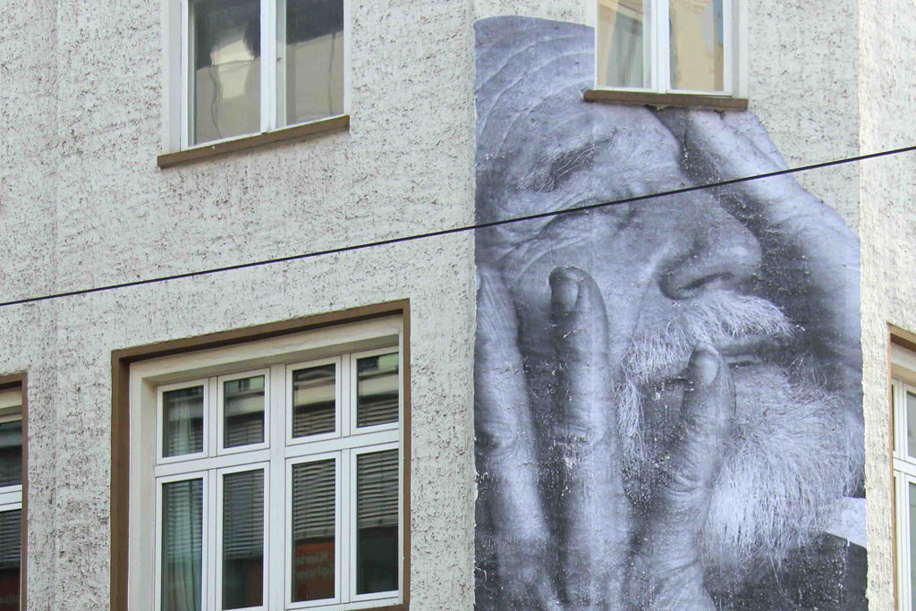 Komet Bernhard - a paste up on the corner of Rosenthaler Straße and Aguststraße by French street artist JR as part of his Wrinkles of the City project in Berlin