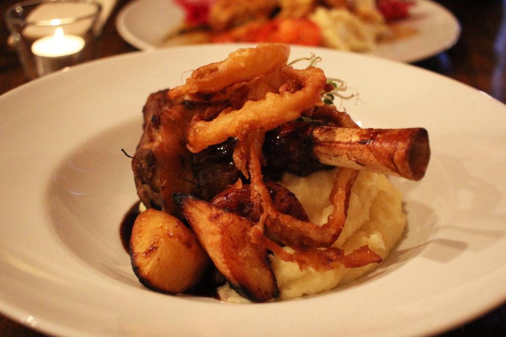 Lamb Shank with Onion Rings and Roast Potatoes at Salt n Bone Berlin